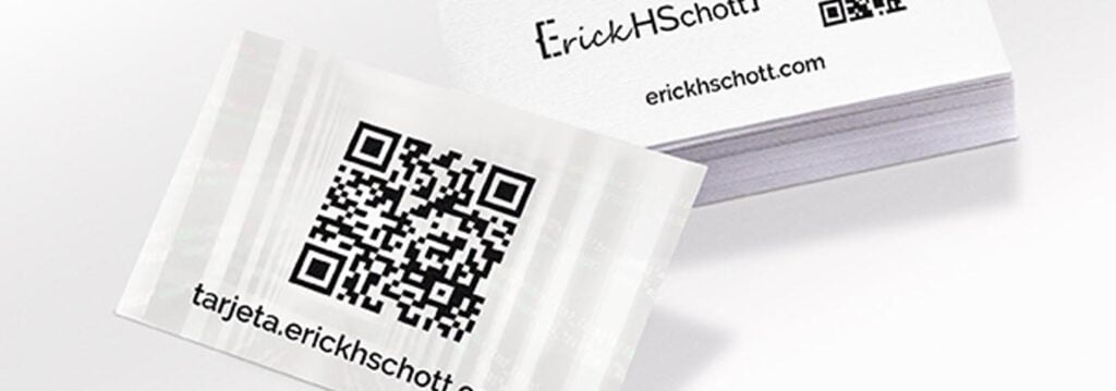 tarjeta de papel sobre un paquete de tarjetas, todas las tarjetas están impresas con logo que dice ErickHSchott un código QR impreso y el nombre de la pagina web tarjeta.erickhschott.com